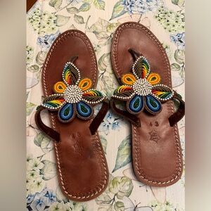leather hand beaded sandals with multi-colored beads.